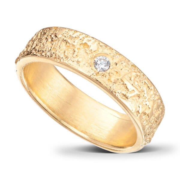 14 K Yellow Gold Wedding Ring. 5 mm wide. Ruffled surface and straight edges. Rounded inside the ring to make it comfortable to wear. 1 Diamond.